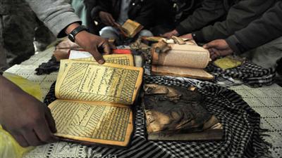 افغان يظهرون عدداً من نسخ المصحف الكريم بعد ان قام جنود اجانب يعملون في قاعدة باغرام بإحراقه امس (ا ف ب)
