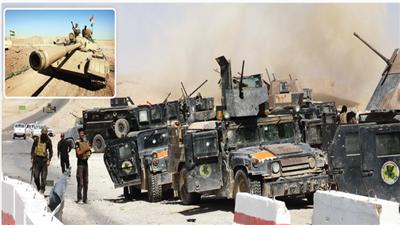 عناصر من القوات العراقية بجوار آليات عسكرية
